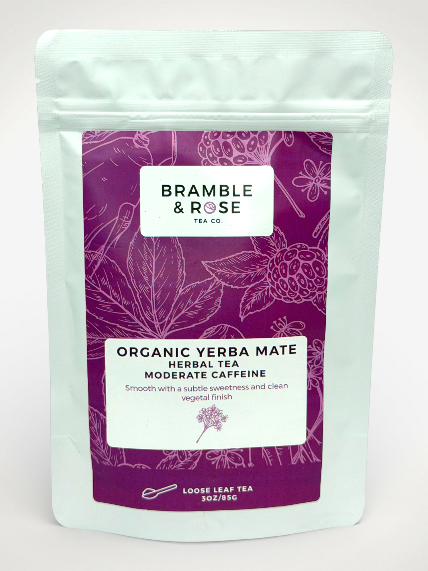 White pouch of Bramble & Rose Organic Yerba Mate Herbal Tea, with a berry colored design featuring fruit illustrations, a white rectangle with product description, and the "Bramble & Rose" logo.