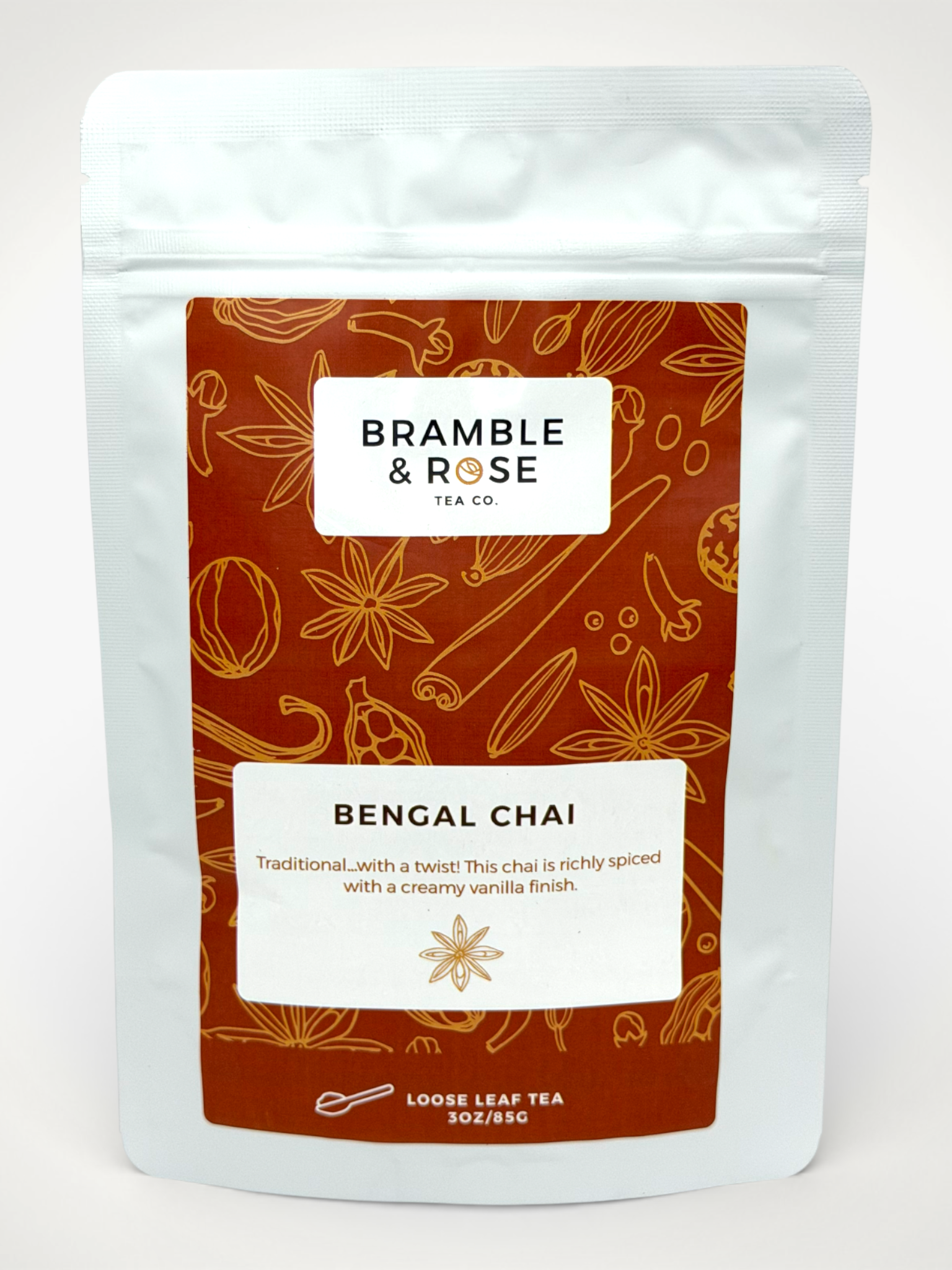 White pouch of Bramble & Rose Bengal Chai Tea, with a burnt orange label featuring various whole spice illustrations, a white rectangle with product description, and the "Bramble & Rose" logo.