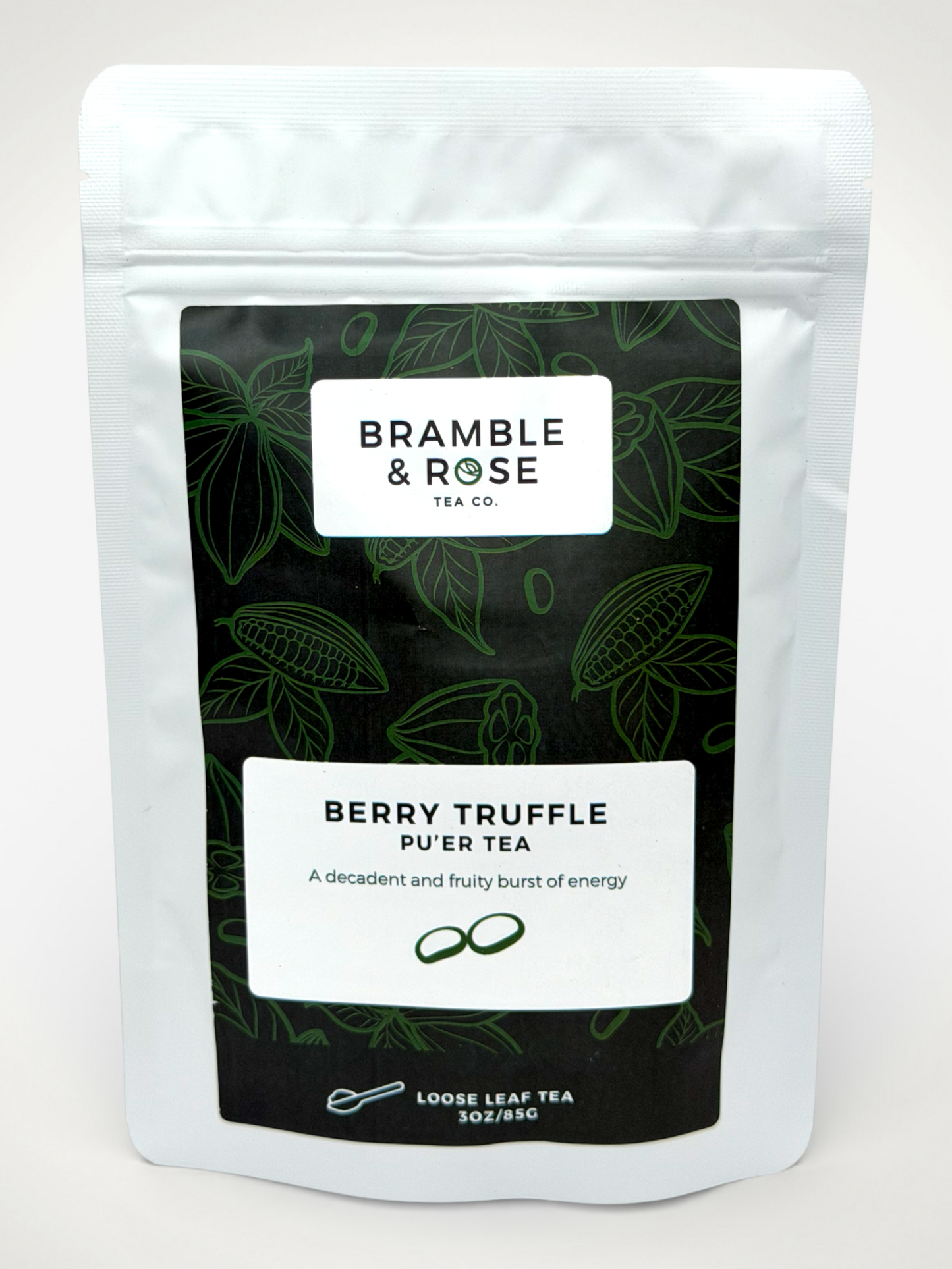 White pouch of Bramble & Rose Berry Truffle Pu-er Tea, with a dark green label with tea leaf and  cocoa pod illustrations, a white rectangle with product description, and the "Bramble & Rose" logo.