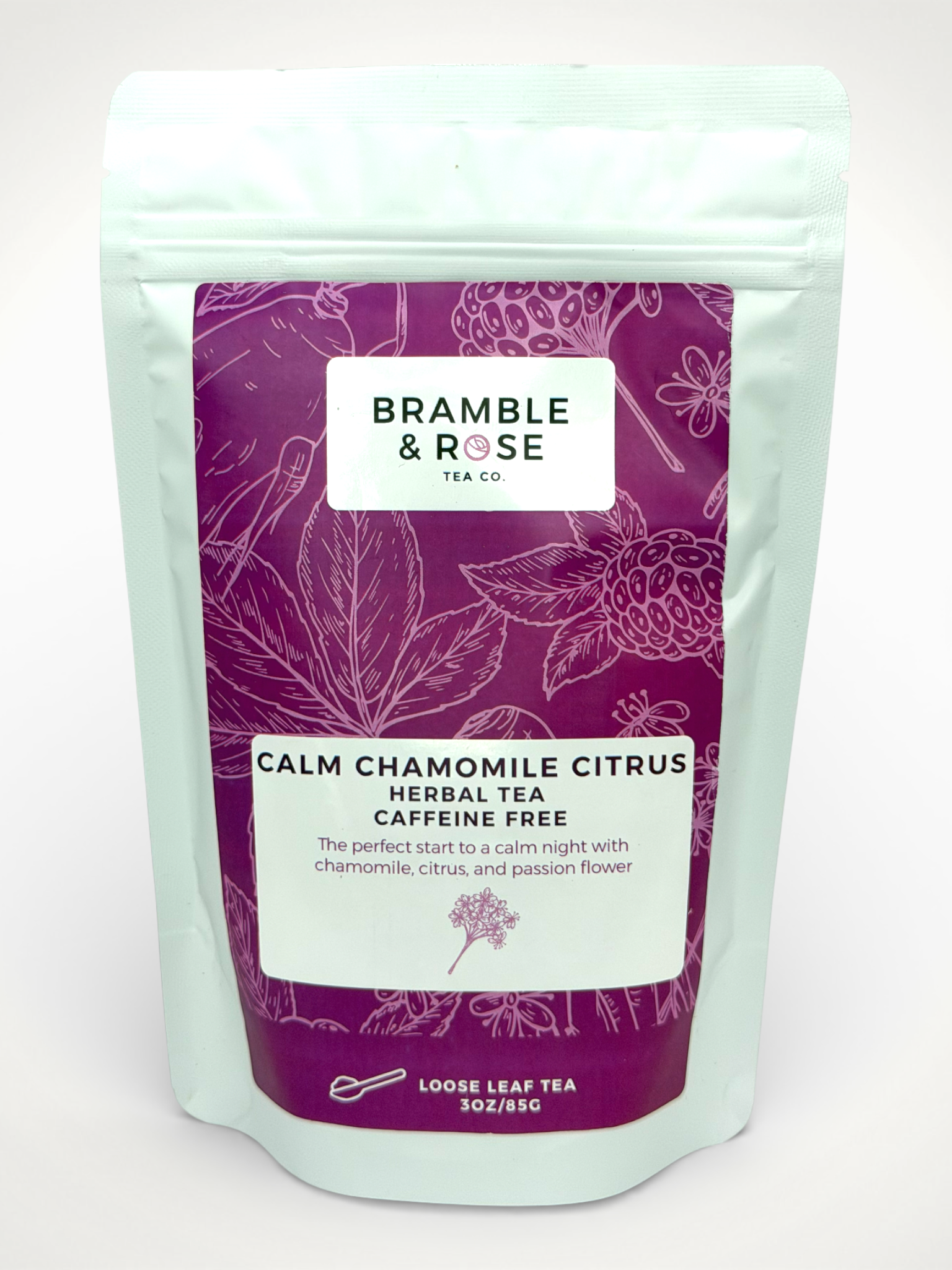 White pouch of Bramble & Rose Calm Cahmomile Citrus White Tea, with a dark berry label design featuring fruit and plant illustrations, a white rectangle with product description, and the "Bramble & Rose" logo.