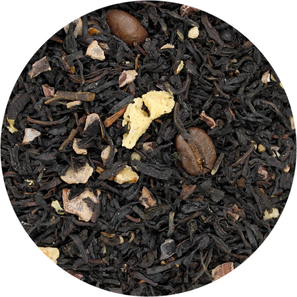 A close-up image of dried black tea leaves with roasted coffee beans, hazelnut brittle, and yogurt bits