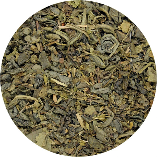 A close-up image of dried gunpowder green tea and peppermint leaves 