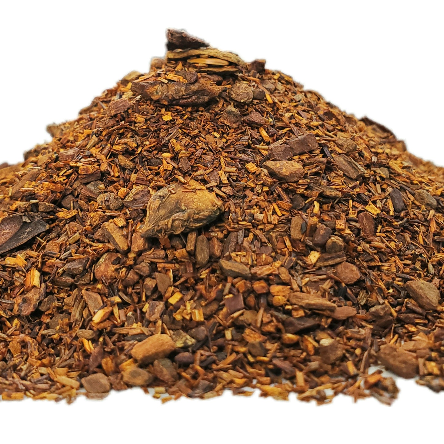 A close-up image of dried red rooibos leaves with pieces of cinnamon and star anise.