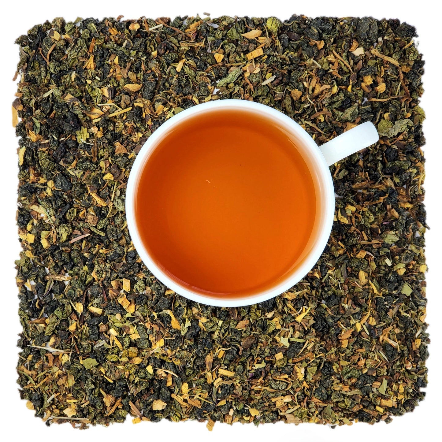 A pile of dried loose tea leaves and herbs, including oolong tea leaves and yellow dried pieces, representing the contents of the 'Dandelion Detox' tea product.