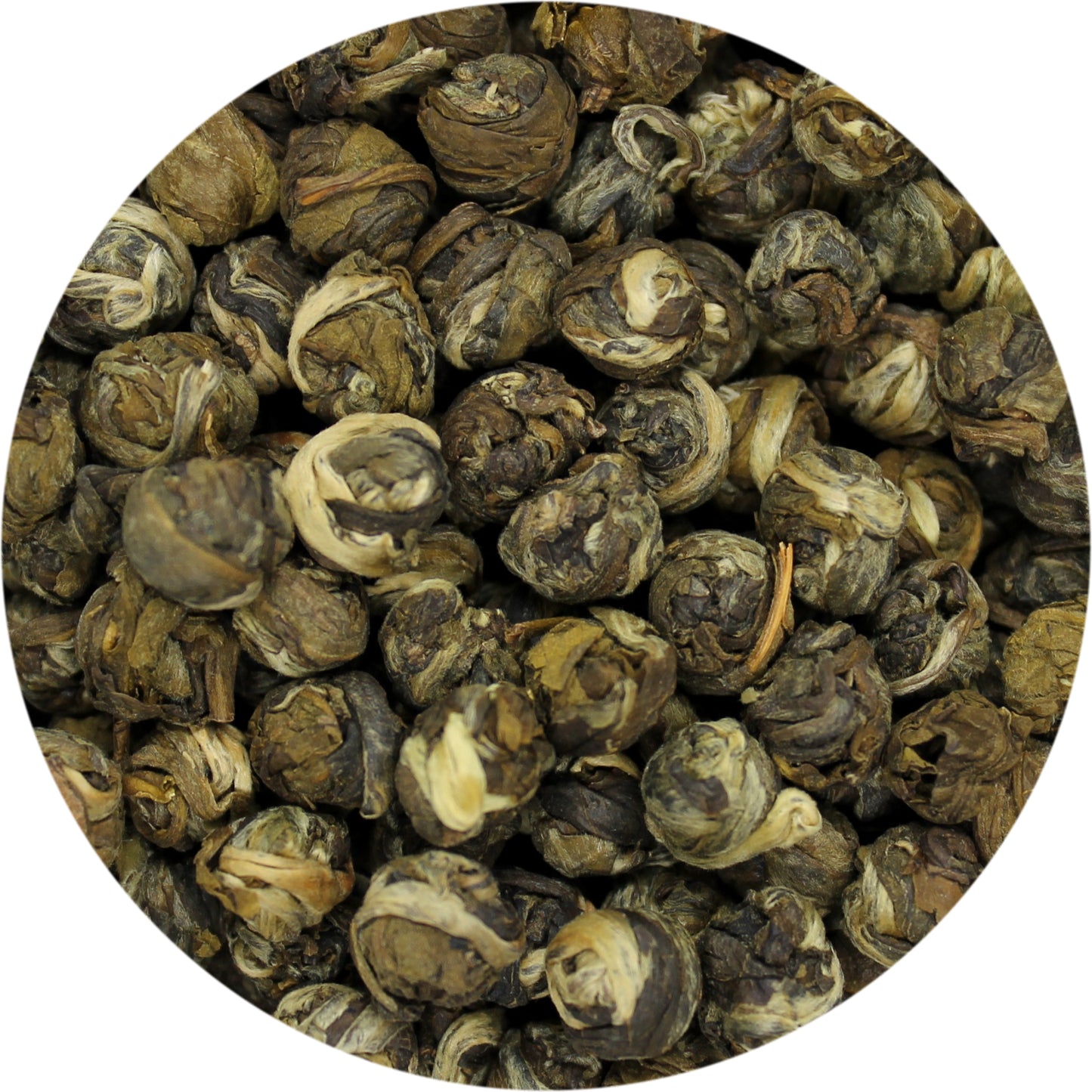 A close-up of dried green tea pearls 