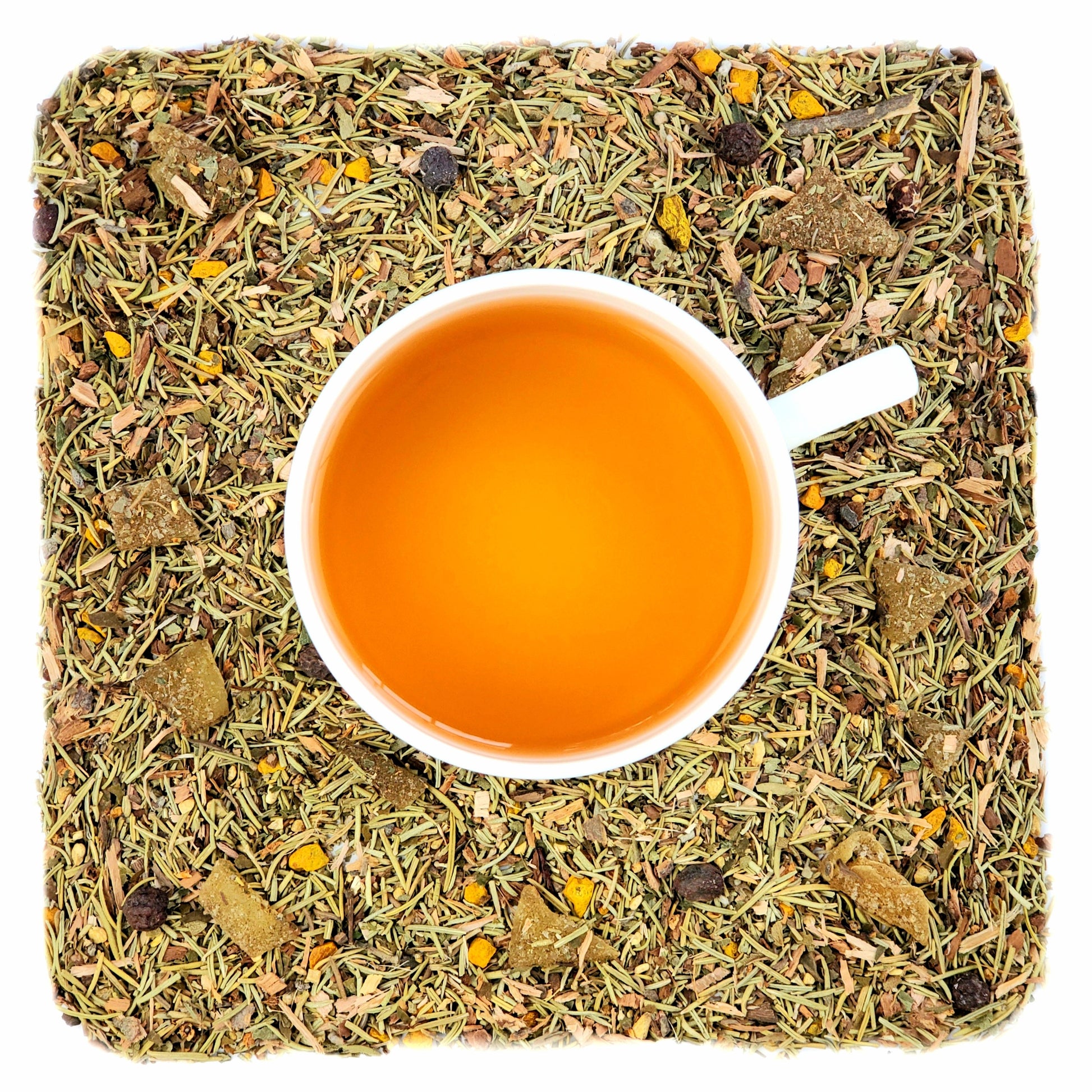 A cup of brewed tea on a bed of dried ginger, turmeric, rosemary, hawthorn, and white willow bark.