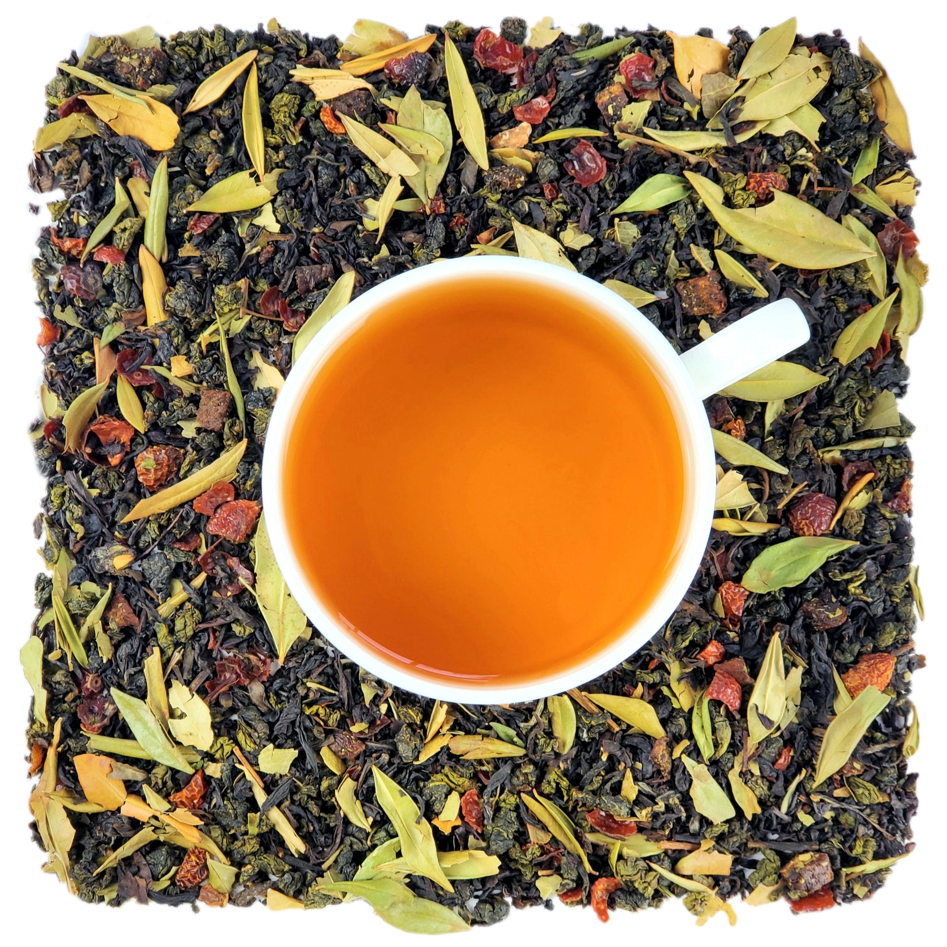 A cup of tea on a bed of dried oolong leaves, and fruit pieces, indicating the ingredients of the tea.