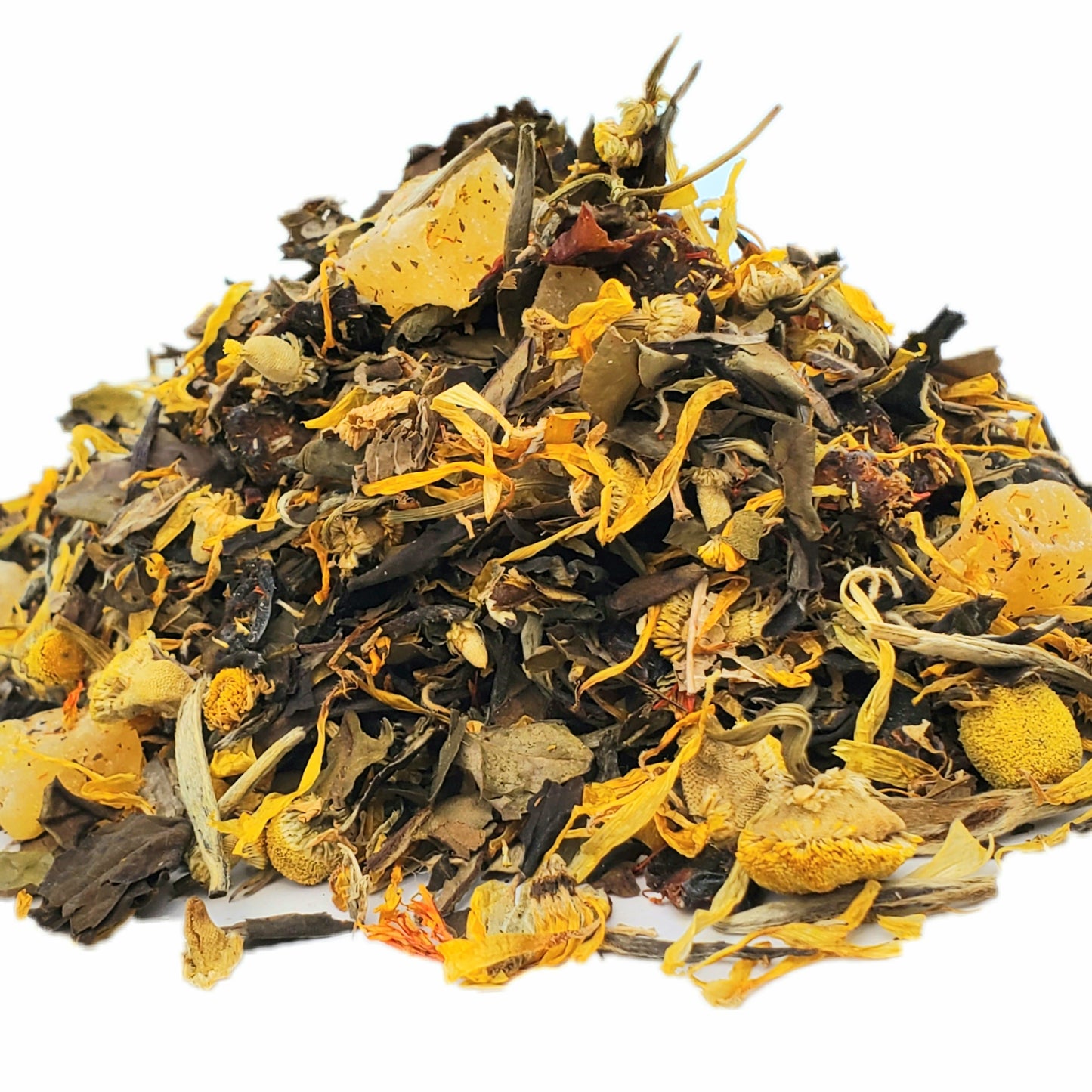 A close-up image of dried white tea leaves with pieces of pineapple, peach, chamomile flowers, and other ingredients found in the tea blend.