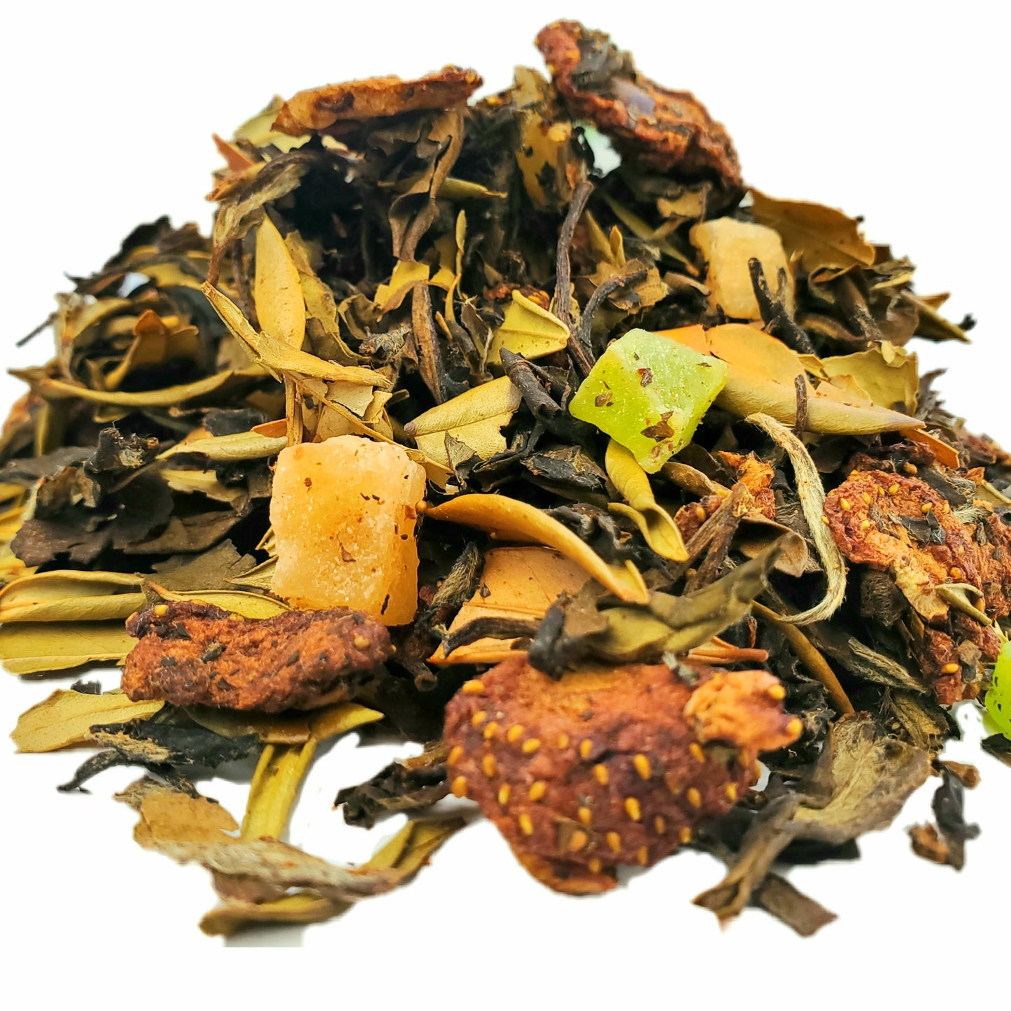 A close-up of dried white tea leaves with pieces of strawberry, pineapple, and kiwi, indicating the ingredients in the tea blend