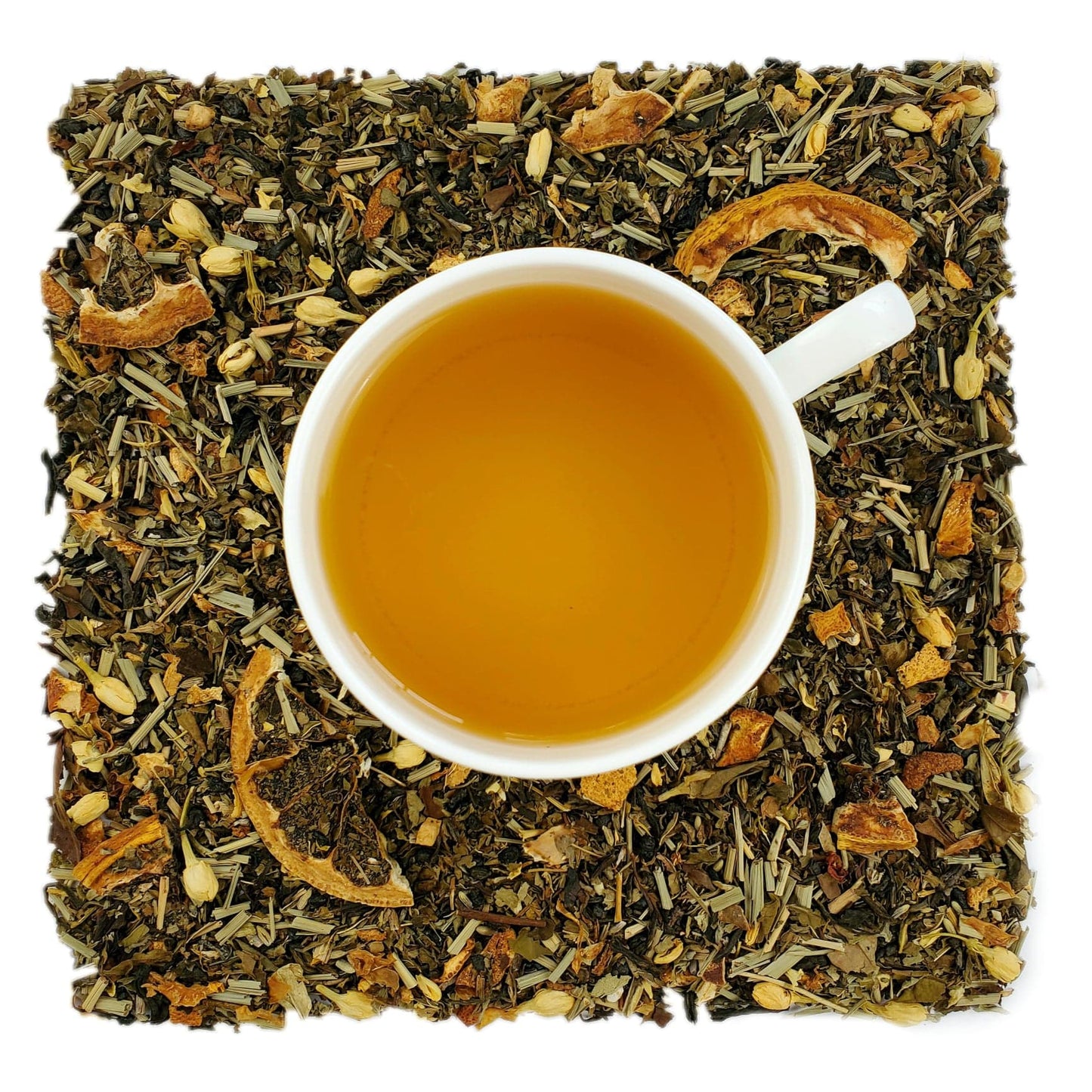 A cup of steeped tea on a bed of dried citrus and mint leaves, herbs, and green tea leaves, indicating the ingredients of the tea blend.