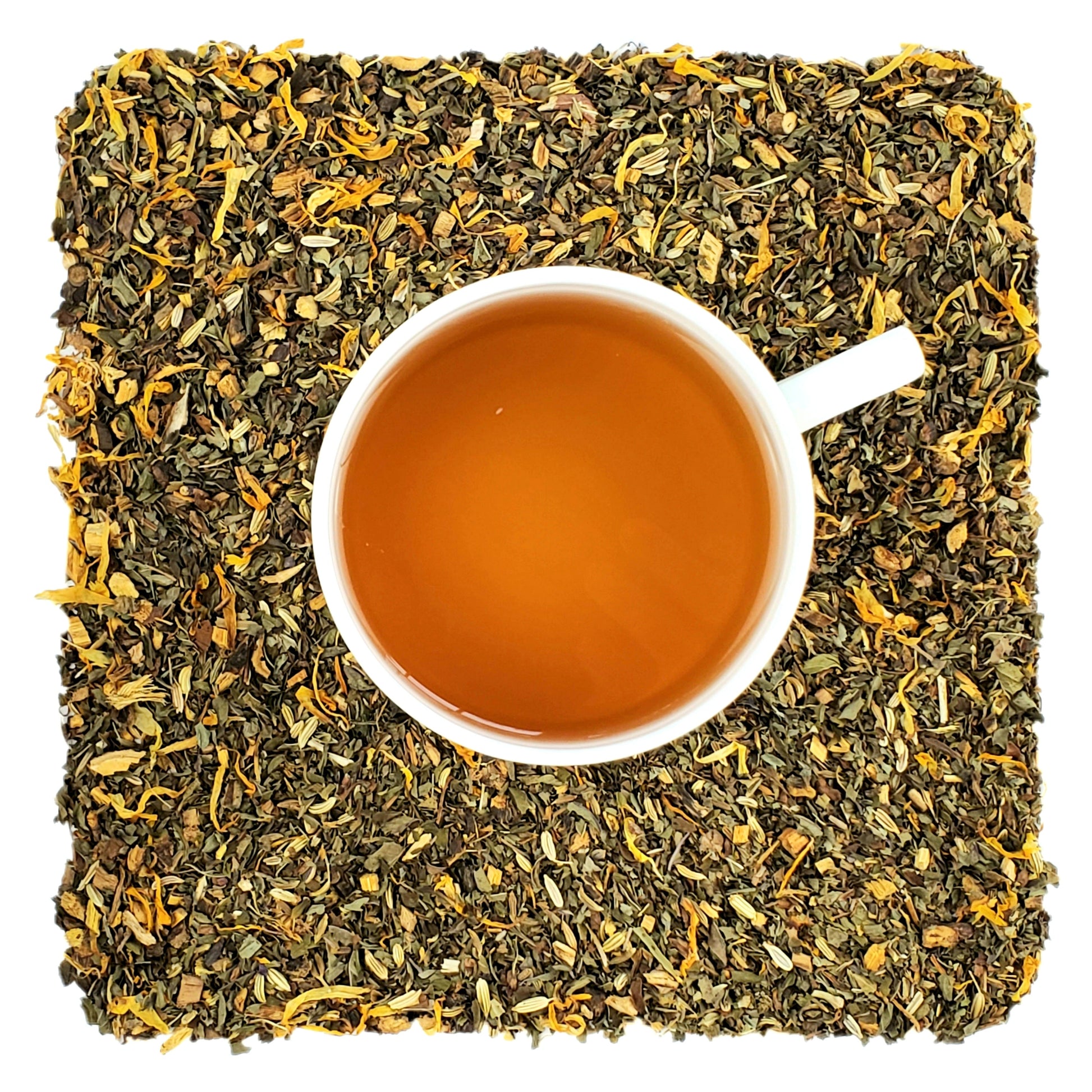 A cup of herbal tea on a bed of dried herbs and flower petals, indicating the ingredients of the tea.